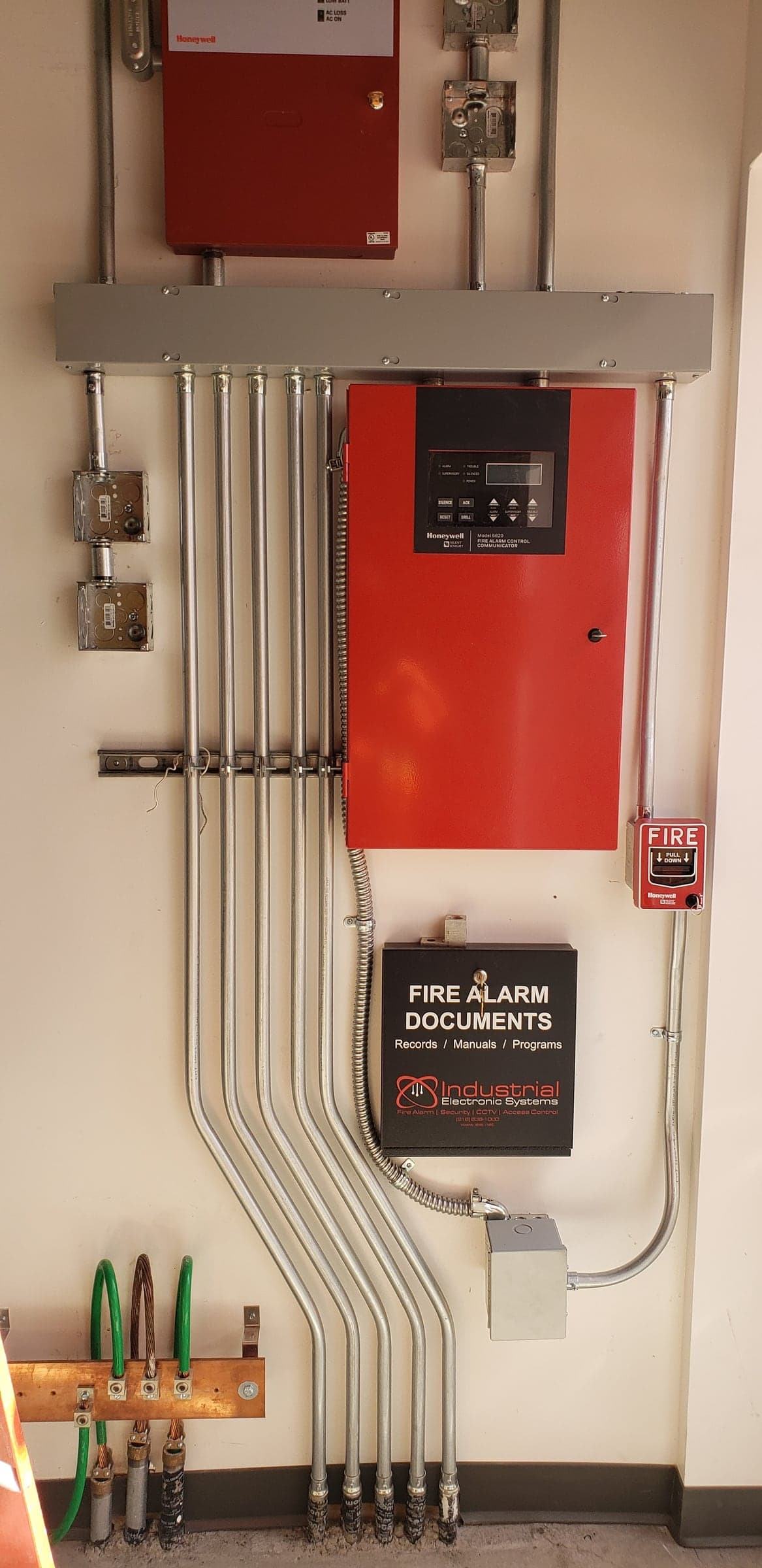 Commercial fire alarm control panel with conduit and a manual pull station in Sacramento, CA