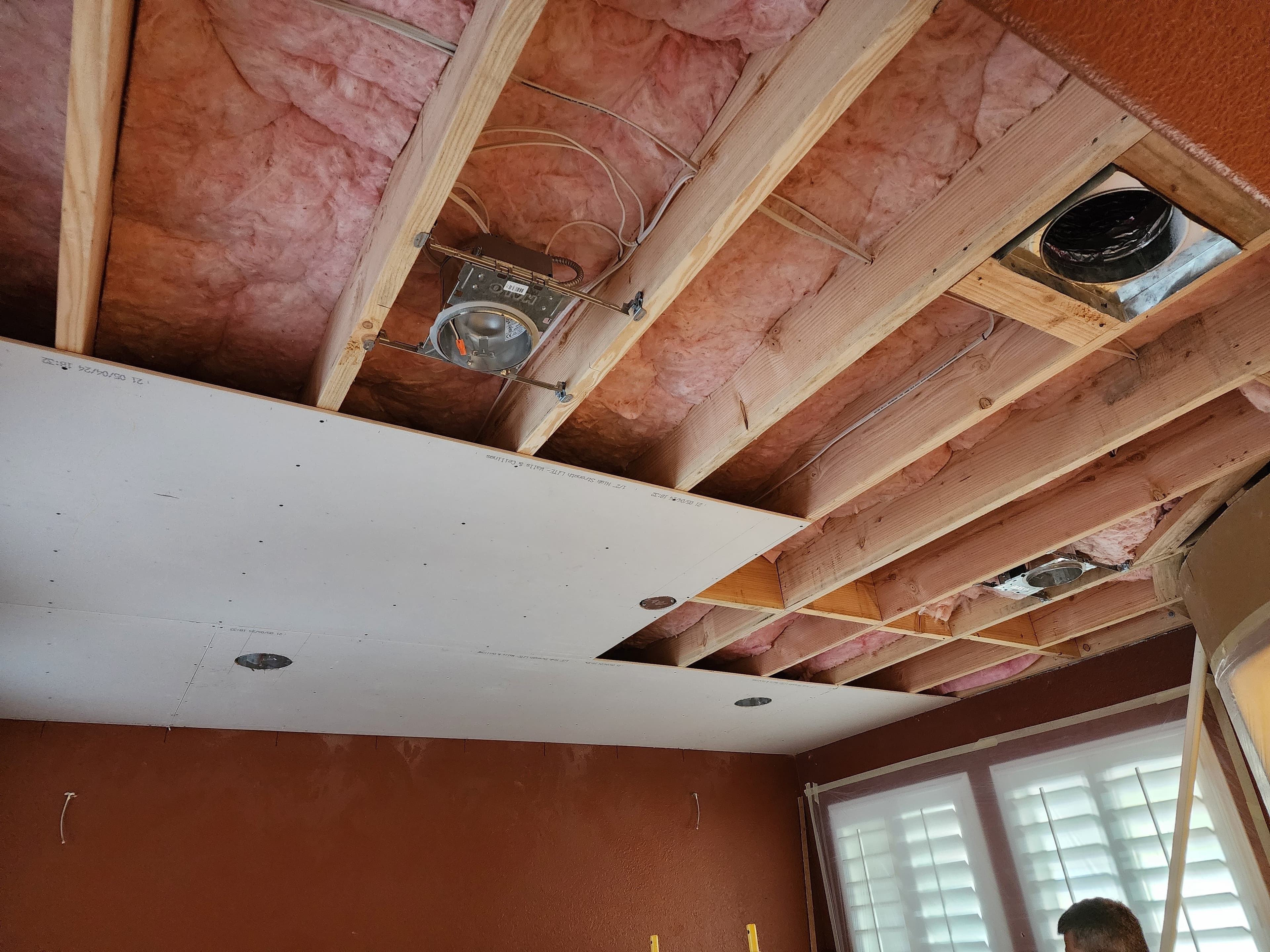 Electrician working at a residential ceiling during a lighting installation