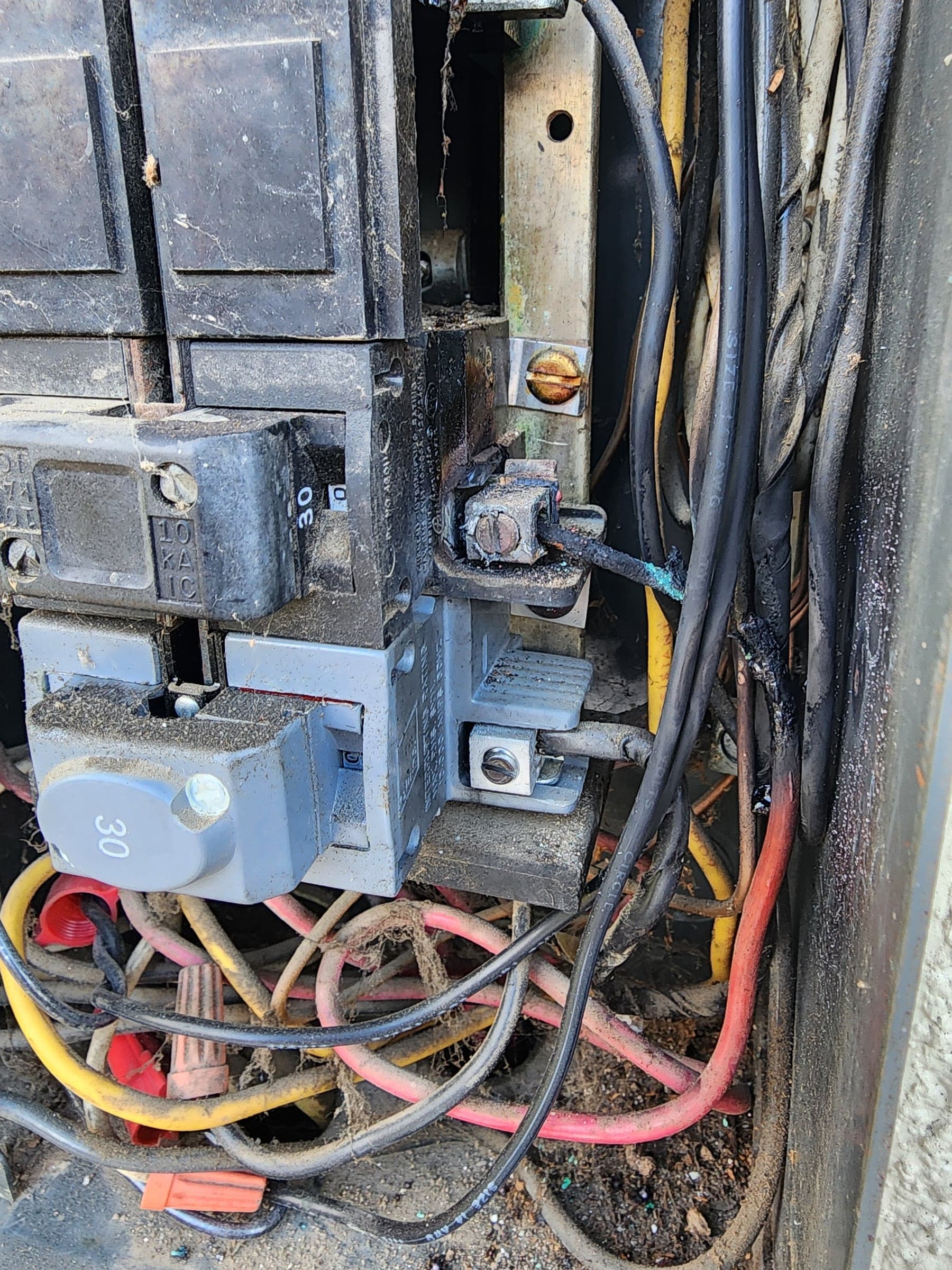 Burned electrical panel with scorched breakers and heat-damaged conductors in Fair Oaks, CA