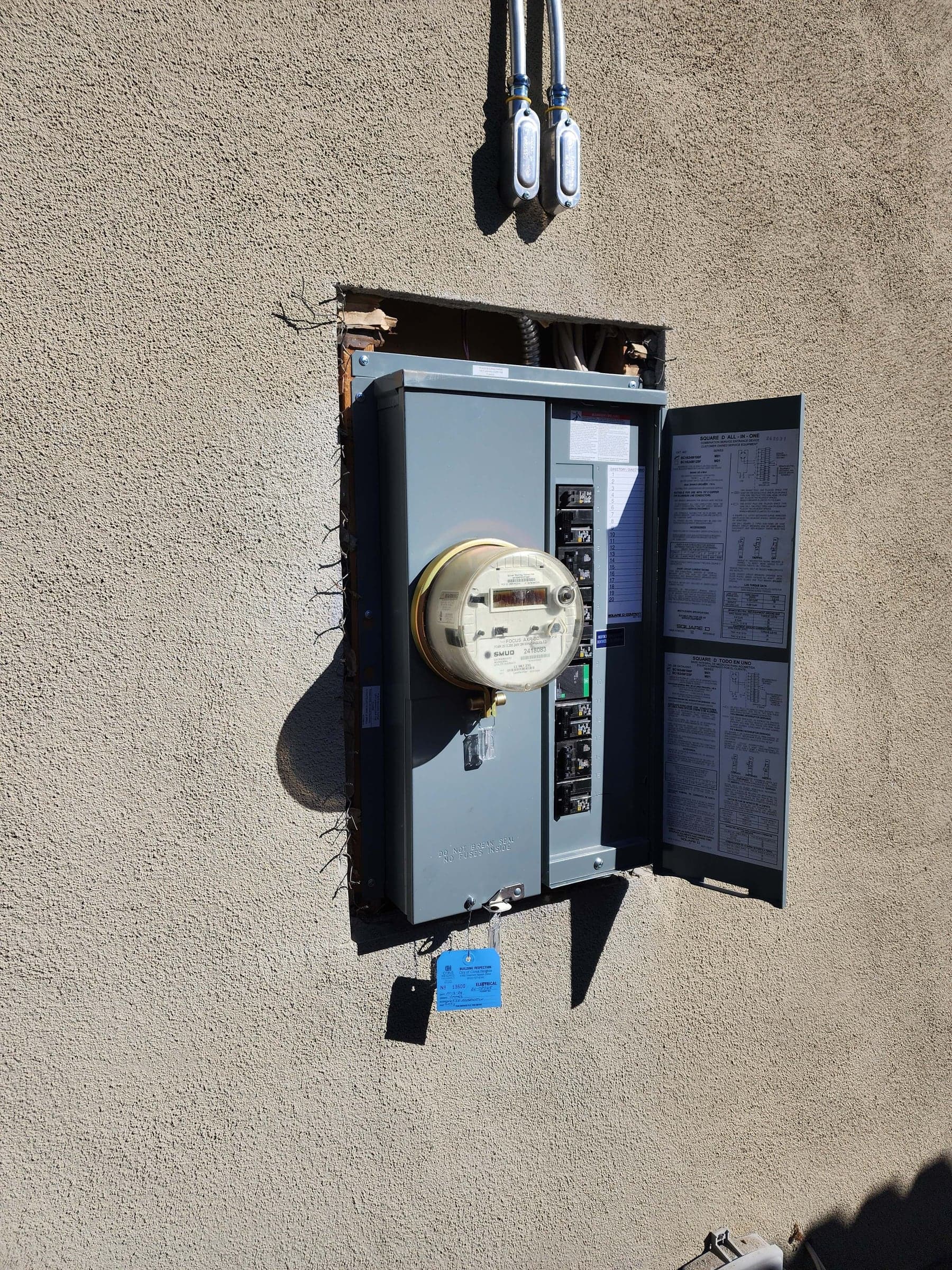 Exterior Square D all-in-one meter-main service upgrade with SMUD meter and a City of Citrus Heights electrical inspection tag