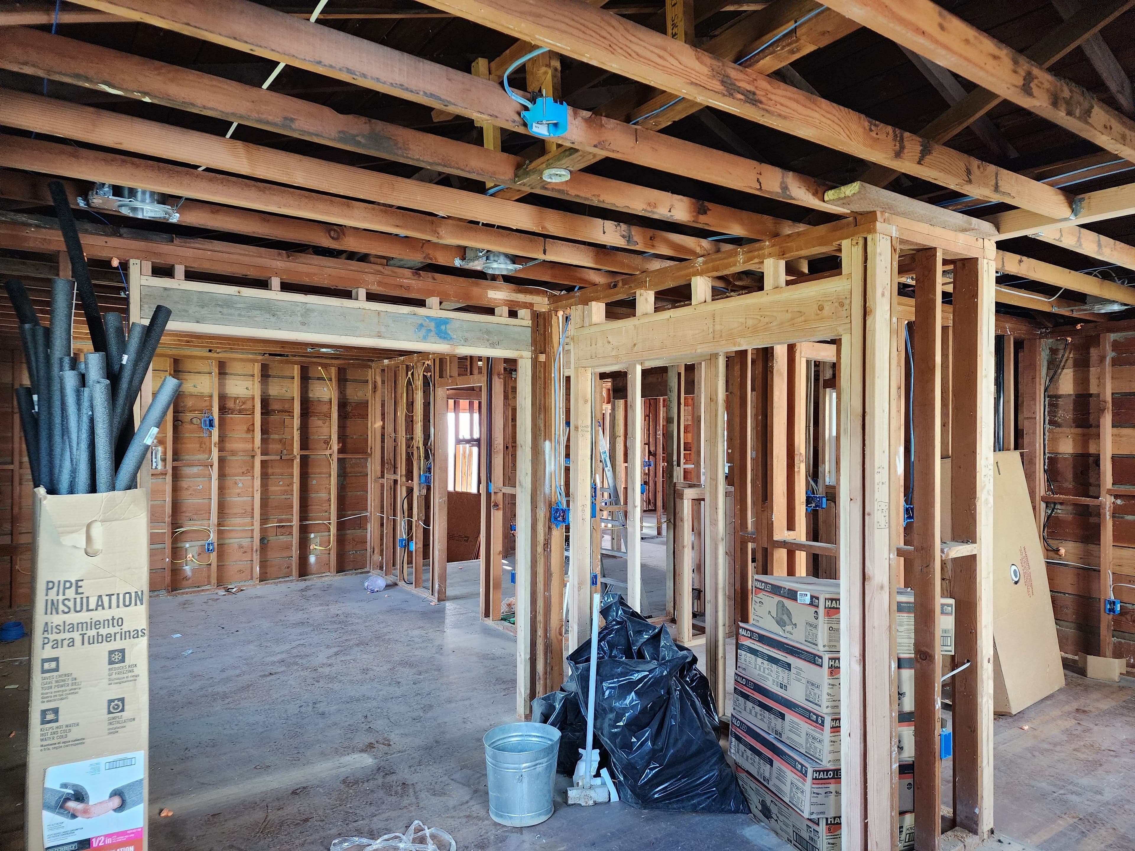 Whole-home rewire rough-in across open framing during a gut remodel